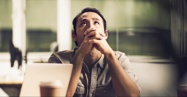 Man praying concernedly