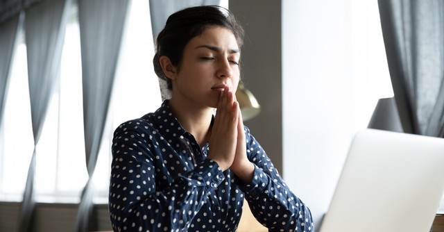 Woman praying in her home