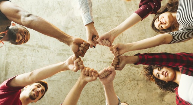 diverse group joining fist in togetherness