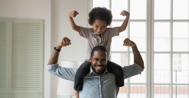 father and son flexing arm muscles being strong