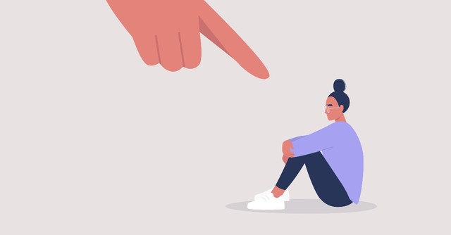 woman sitting with accusing finger pointed at her