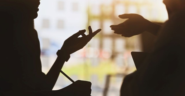 Silhouette of people's hands, gesturing and talking