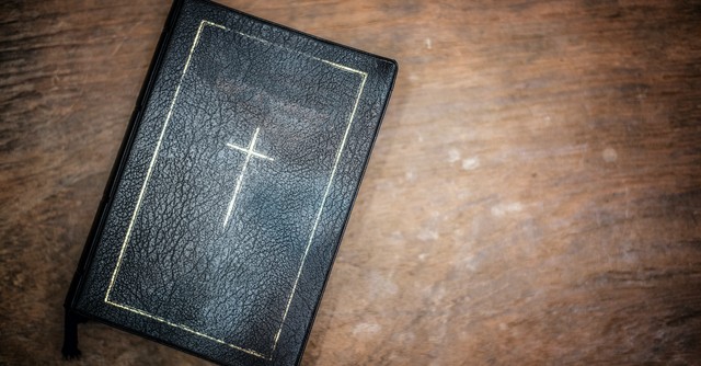 Bible with cross design on top