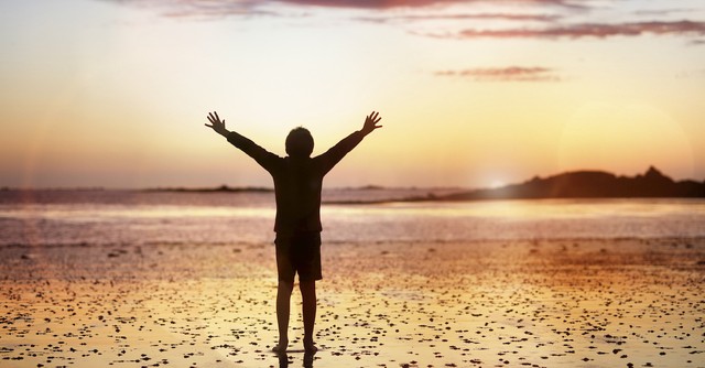 person on beach near sunset