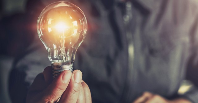 man holding a lightbulb
