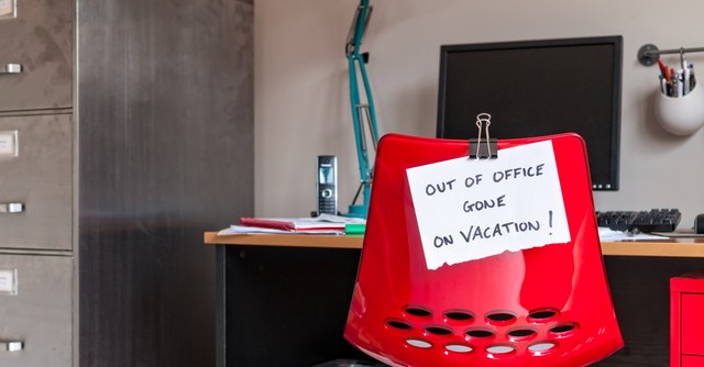 Desk chair with "out of office" message on the back