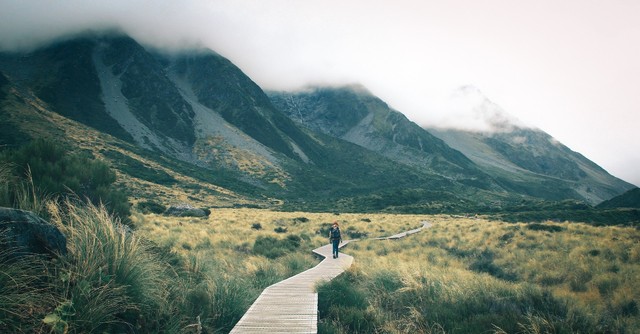 Man walking down a mountain path
