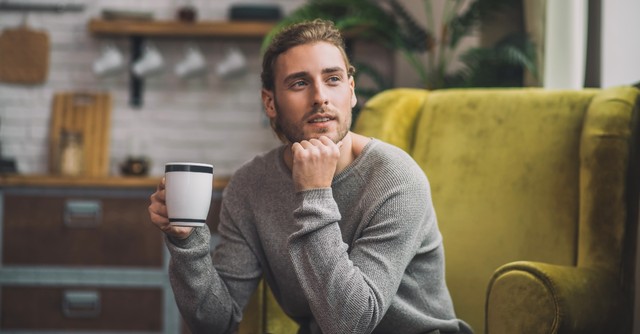 Man contemplating with a cup of coffee