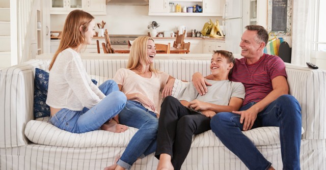 a family sitting on a couch