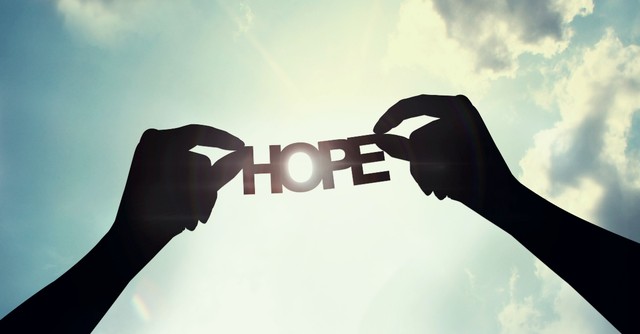 Word hope silhouetted against a blue sky