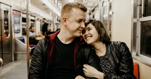 a happy couple smiling at each other; thank or compliment family and friends in public
