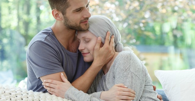A husband hugging his wife who has cancer