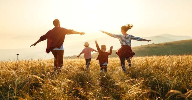 Family running in a field