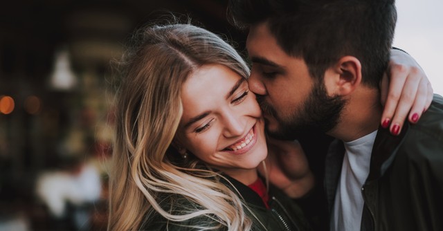 Husband kissing his wife on the cheek