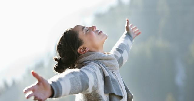 Woman with arms raised in worship