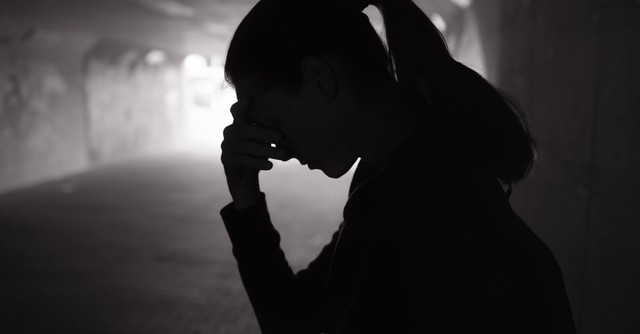 Silhouette of a worried woman