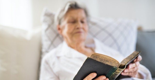 Woman reading the Bible in bed