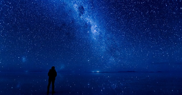 Person staring up at a starry sky