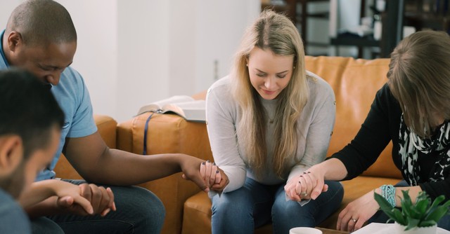 Group holding hands and praying