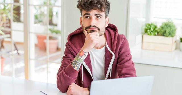 Young man looking up thoughtfully