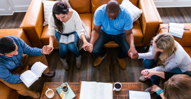 Bible study holding hands and praying