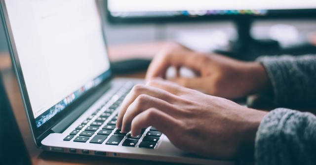 a person typing on a computer