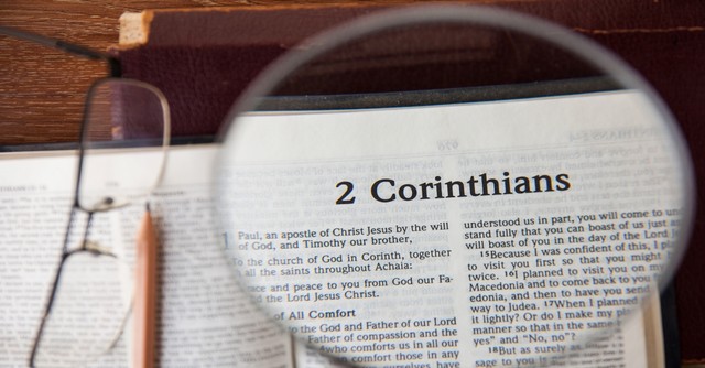 Magnifying glass over first page of 2 corinthians