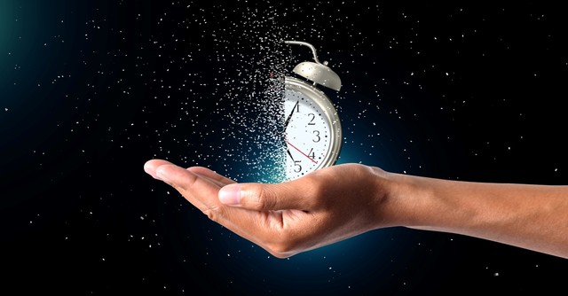 Hand holding disintegrating clock