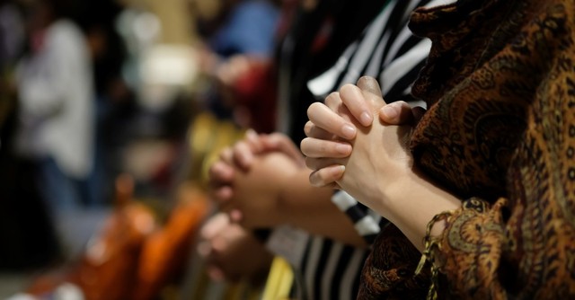 women praying in church, pray for a healthy church