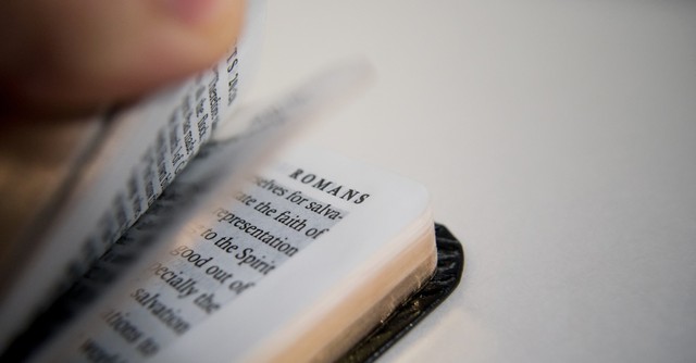 Book of Romans flipped open
