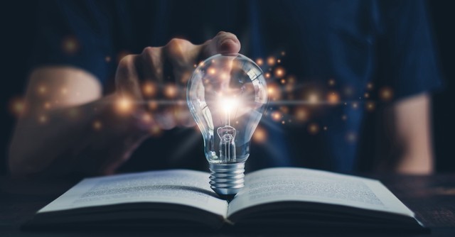 Lightbulb coming out of a book