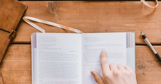 Hand over the Bible in study