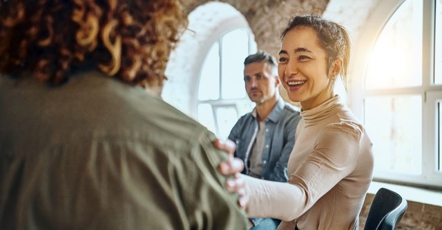 A group of friendly people smiling, meeting each other