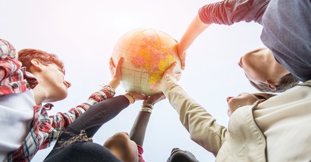 People holding up a globe