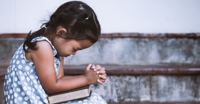 a little girl praying