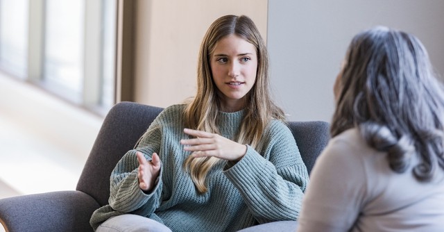 Woman talking to another