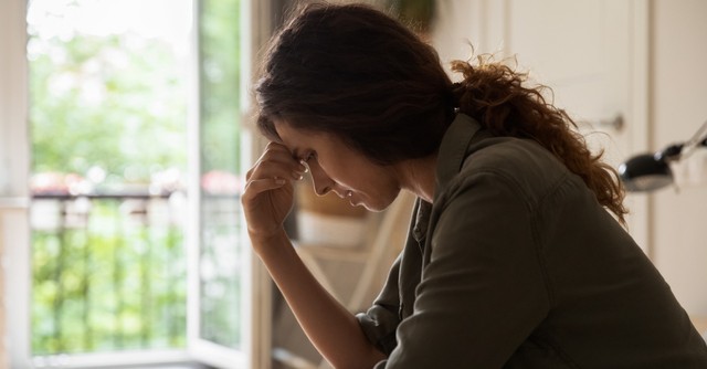 A woman looking worried, sad