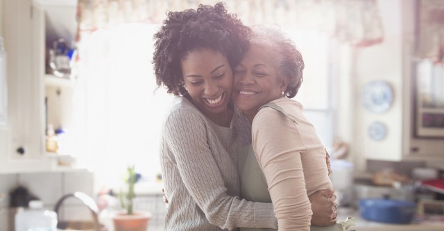 older mother and daughter hugging