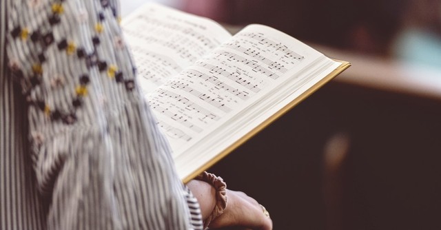 woman reading hymn book