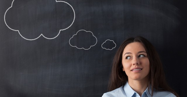Woman with thought bubbles drawn behind her head