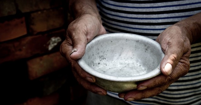 man holding empty tin bowl
