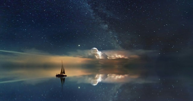 Sailboat on the water at night