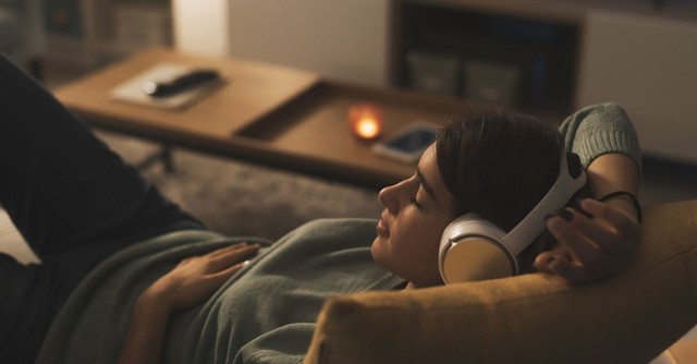 Woman relaxing on the couch at night