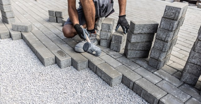 A man putting down bricks as a strong foundation