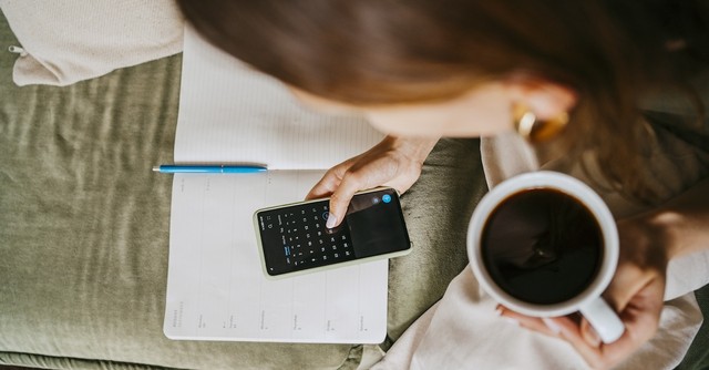 Woman planning calendar mug coffee schedule