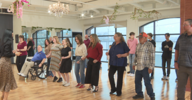 a woman dancing with a group of people