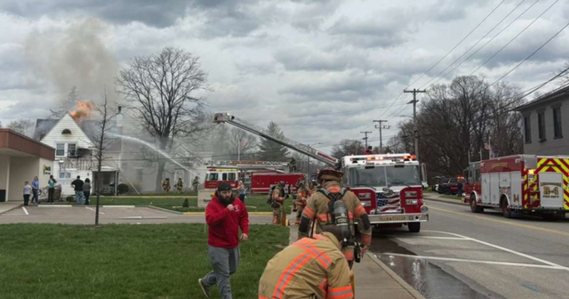 firefighters with firetrucks putting out a house fire