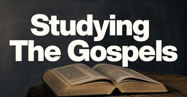 Studying The Gospels banner over an open, aged Bible on a wooden table