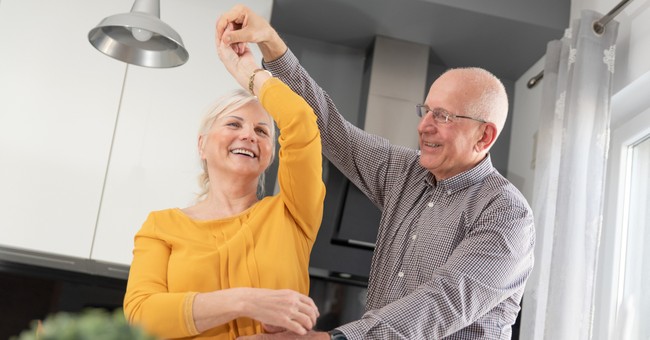 senior couple dancing in kitchen