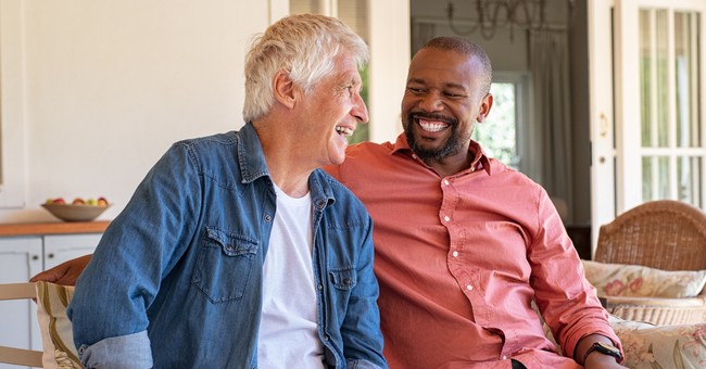two men having a conversation smiling